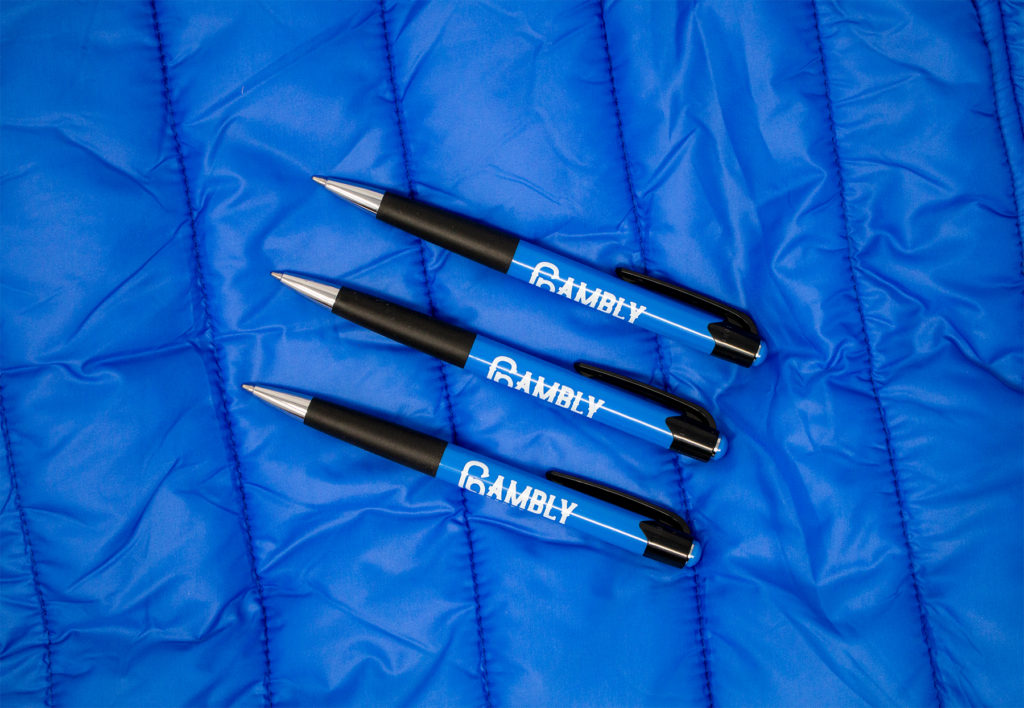 Mardi Gras blue promotional pens on a blue background