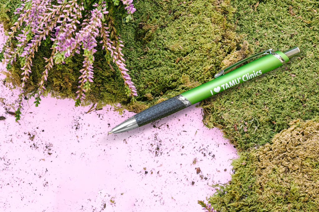 XeeDee green promotional pen on green moss
