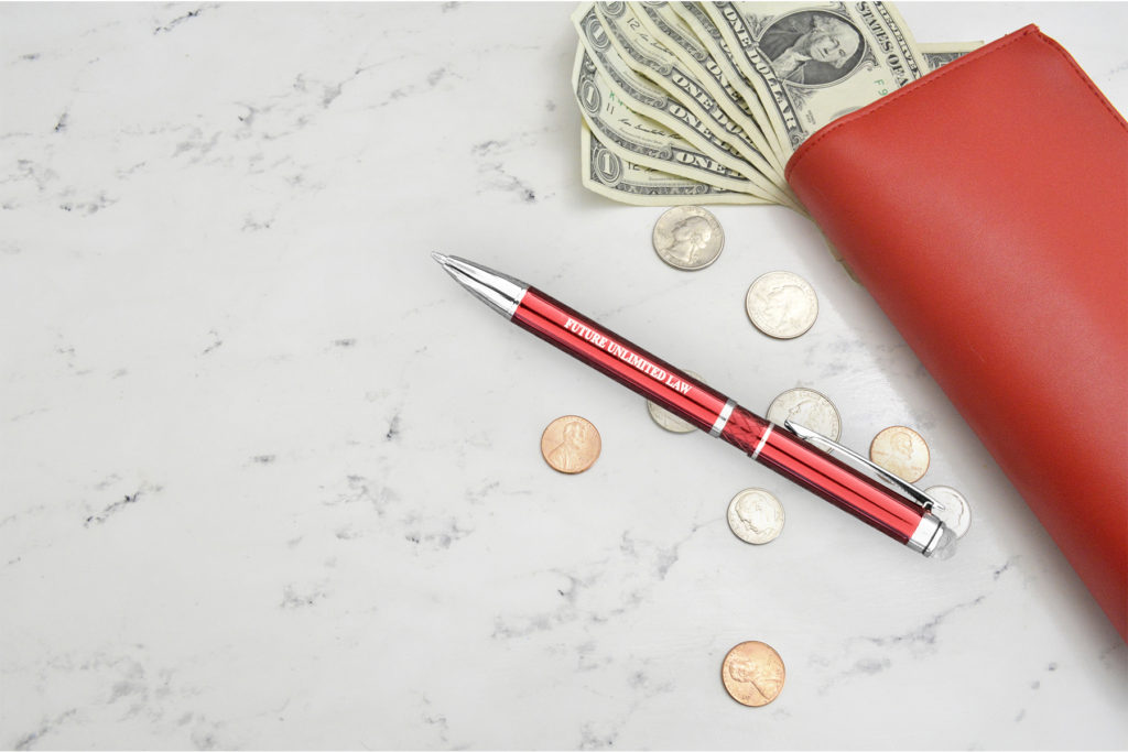 Farella Stylus pen in red on a marble counter with money